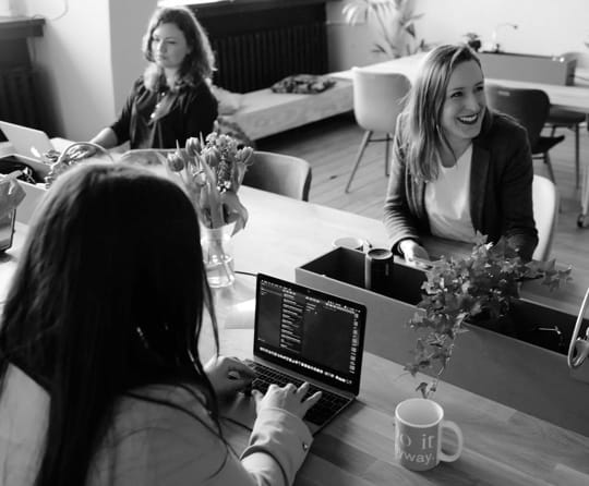 Computer workplace area with people